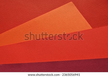 Background concept. Combinations of multi-colored sheets of orange, pink andcolored paper in different shades. Copy space, top view, background.
