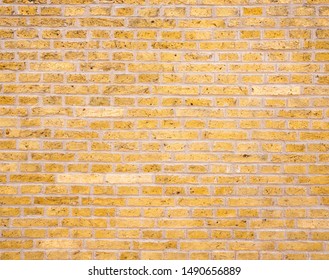 background consisiting of yellow or gold colored brick wall