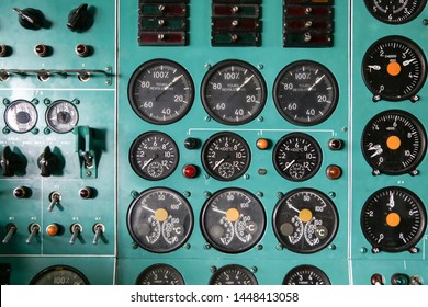 background of control panel in the cockpit. lights, analog gauges, and buttons in the dashboard panel of the old aircraft. 