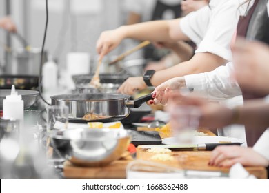Background cook leads master class in cooking in kitchen. - Shutterstock ID 1668362488
