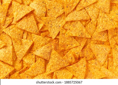 Background Of Corn Tortilla Chips Or Nachos, Top View. Mexican Nachos Chips Texture Background.