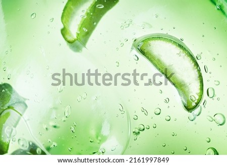 background of cosmetic aloe gel with aloe slices
