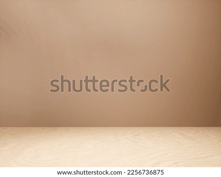 Background for a cosmetic, fragrance or beverage product packshot - brown plaster wall and wooden table in the foreground