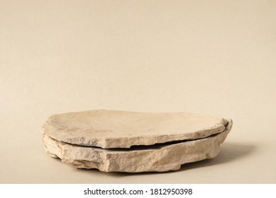 Background for cosmetic products of natural beige color. Stone podium on a white background. Front view.