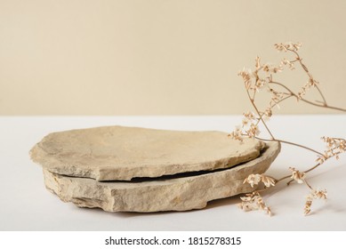 Background for cosmetic products of natural beige color. Stone podium and dry flower on a white background. Front view. - Shutterstock ID 1815278315
