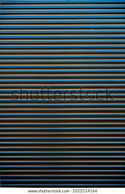The\
background of dark blue metal door of\
garage