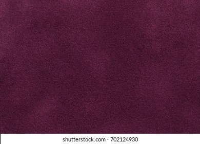 Background Of Dark Purple Suede Fabric Closeup. Velvet Matt Texture Of Wine Nubuck Textile.