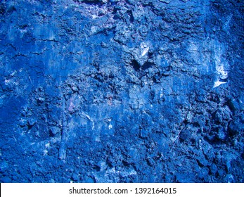 Background of dense cut clay. The main color is cobalt blue. White inclusions, cracks, texture.                              
