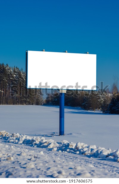 Background for design. Advertising\
billboard along the road in the city on a winter sunny\
day