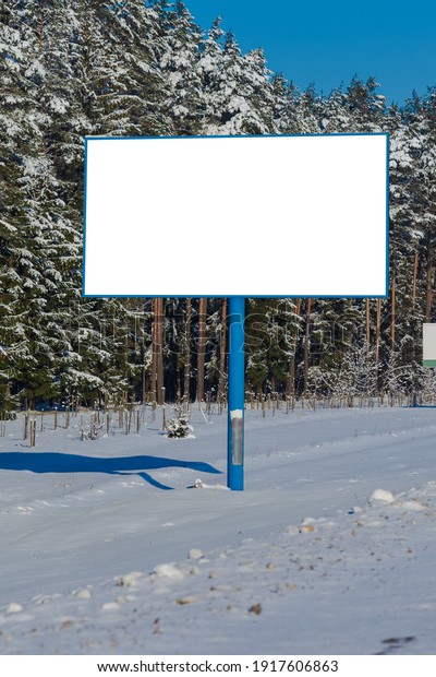 Background for design. Advertising\
billboard along the road in the city on a winter sunny\
day