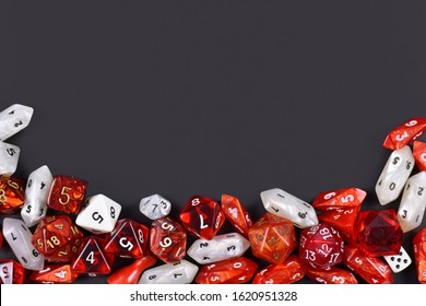 Background With Different Roleplaying RPG Dice At Bottom Of Dark Black Background With Blank Copy Space