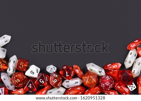 Background with different roleplaying RPG dice at bottom of dark black background with blank copy space