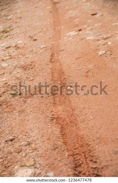 Background\
Dirty slippery tracks of automobile tires in clay. Road wheel on\
land all terrain. A dirty mud road, wet in spring. Extreme traces\
of off-road driving. Traces from the\
car.