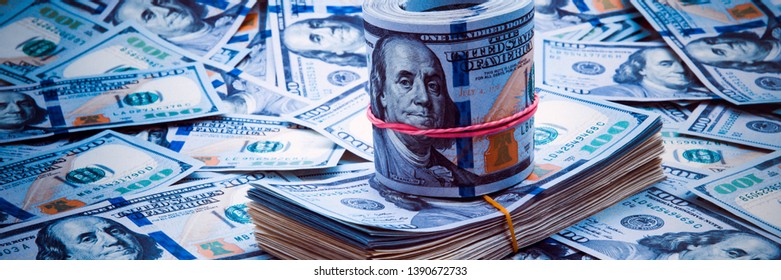 Background from dollars. Notes of one hundred American dollars are scattered across the background.