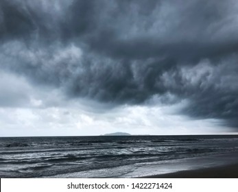 Background Of Dramatic Heavy Dark Clouds Over The Dark Beach