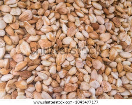 Background from a dry kernels of walnuts. Close-up texture of heap of unshelled walnuts, overhead view. Healthy food.