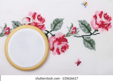 background with embroidered cross on canvas patterns of flowers roses