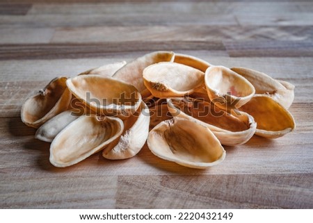 Background with empty pistachio nuts without kernel on the table. Concept: empty promises, broken promises, disappointment