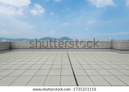 Background of empty platform under blue sky.