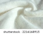 Background fabric texture of Angora. Background texture of white pattern knitted fabric made of cotton or wool or angora close up.