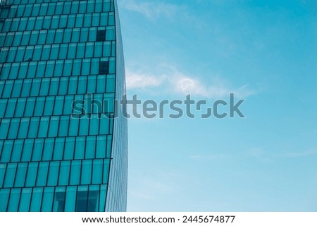 Background of facade of office building and blue sky. Glass buildings in Milan, Italy. CityLife Shopping District complex. Finance, economics, future concepts