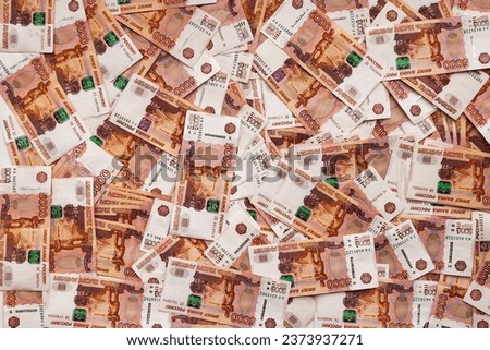 Background of five thousand russian rubles banknotes, one million cash money, full frame. Top view of many scattered banknotes 5000 ruble notes on table. Exchange currency concept. Copy ad text space