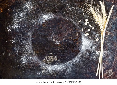 Background- flour over rustic dark metal surface. 