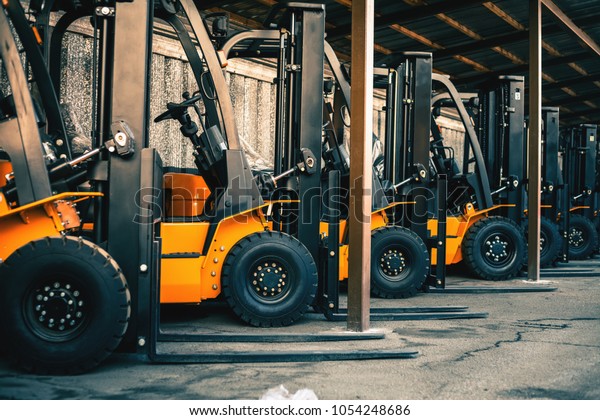 Background of a lot of forklifts,\
reliable heavy loader, truck. Heavy duty equipment,\
forklift