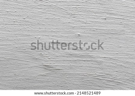 The background is in the form of a fragment of a plastered and whitewashed chalk wall. Tecture of whitewashed plaster.