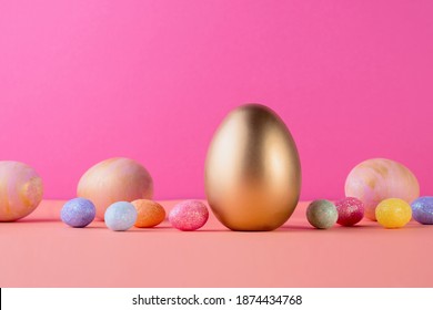 Background and Gold   colored Easter eggs light coral color background and copy space for text  Top view flat lay still life  