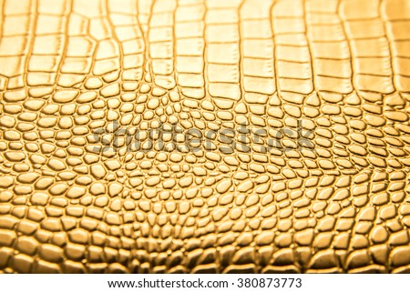 background of gold lizard armor pattern. Snake yellow or golden skin