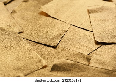 Background of gold textured foil sheets. Pieces of gold foil. - Shutterstock ID 2320108191