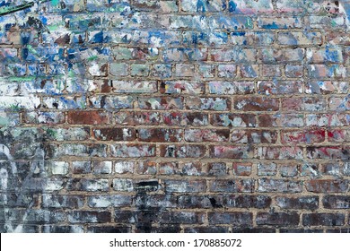 Background of graffiti painted brick wall