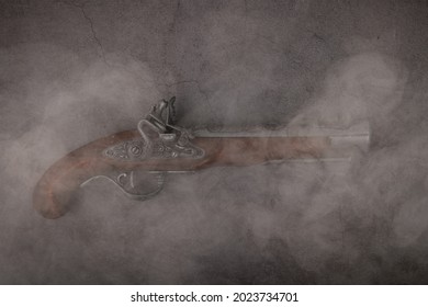 The background is gray concrete with an old gun on it.