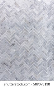 Background Of Grey And White Marble Tile In Herringbone Pattern