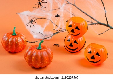Background for Halloween. Decorations for Halloween on an orange background with place for text. Pumpkins, cobwebs and spiders on an orange background. Halloween party - Powered by Shutterstock