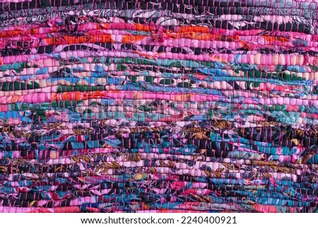 background of handmade fabric sewn with ethnic multicolor threads in Viva Magenta tone horizontally