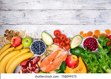 Background of healthy food for heart. Healthy food, diet and healthy life concept. Fresh fish, fruits, vegetables, berries and nuts. Top view, copy space