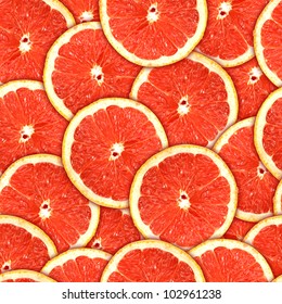  background of heap fresh red grapefruit slices. Seamless pattern for your design. Close-up. Studio photography.