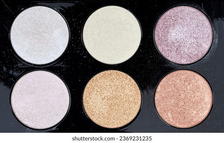 background of highlighter and glitter on purple background, Cosmetic products for makeup, skin care, contouring. Top view