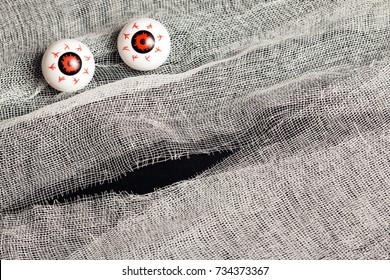 Background For The Holiday Halloween In The Style Of The Mummy. White Bandage And Big Eyes On A Black Background.