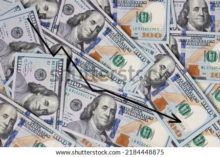 Background of hundred-dollar bills with a graph of the fall. The texture of hundred-dollar bills. A lot of dollars