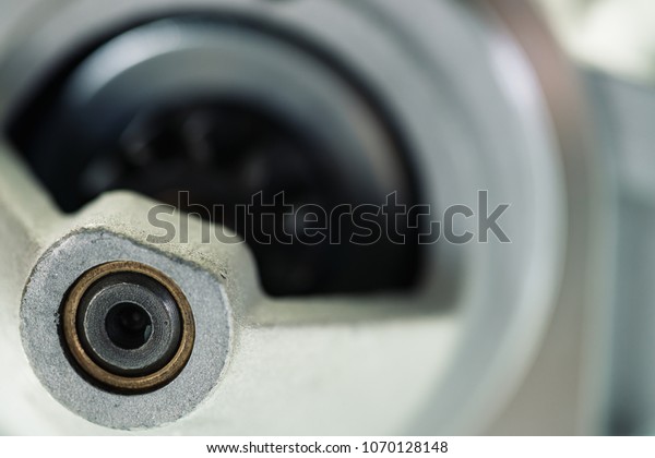 Background image of auto parts\
with rotor close-up. Big black pinion in metal part. Gear parts\
inside.