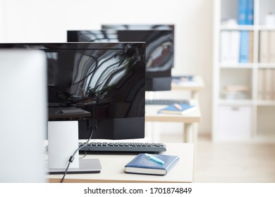 Background Image Of Black Computers In Row At Empty Workplace In Office Cubicles, Copy Space