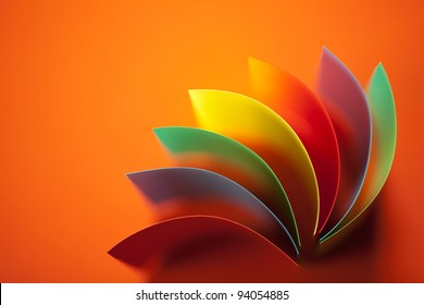 background image of colorful origami fan pattern made of curved sheets of paper, on orange background