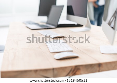 background image of computer and laptop on office Desk