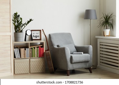 Background image of cozy reading nook in modern minimal interior, focus on grey armchair against white wall, copy space - Powered by Shutterstock