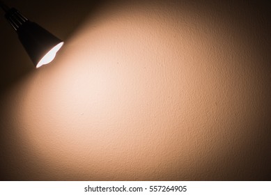 Background image of dark wall with old lamp at night time vintage style
