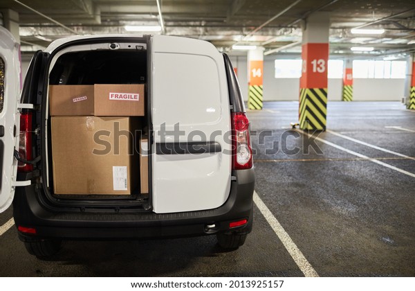 Background image of delivery van or\
moving van filled with boxes at parking lot, copy\
space