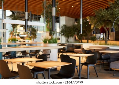 Background image of empty food court interior with wooden tables and warm cozy light setting, copy space - Powered by Shutterstock